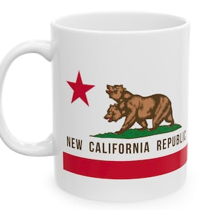 May include: White ceramic mug with a red star and a brown bear with two heads on a green field. The text "New California Republic" is printed on the mug.