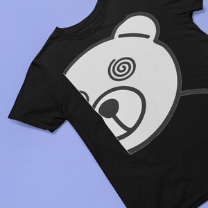 May include: Black t-shirt with a white bear face graphic. The bear has a spiral design in one eye.