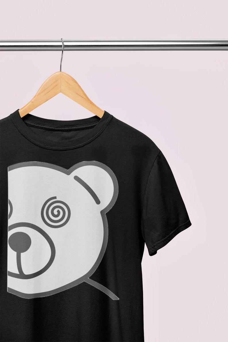 May include: A black t-shirt with a white graphic of a bear's face with a spiral design in its eye.