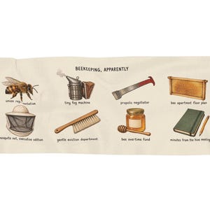 May include: A cream-colored rectangular textile featuring the text BEEKEEPING, APPARENTLY and illustrations of a bee, smoker, hive tool, frame, veil, brush, honey jar with dipper, and a notebook with pencil, each with humorous descriptive labels.