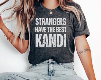 May include: A dark grey t-shirt with a white distressed graphic that reads "Strangers Have The Best Kandi".
