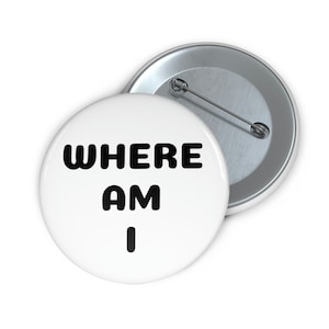 Könnte beinhalten: Weißer Knopf mit schwarzem Text, der "WHERE AM I" lautet