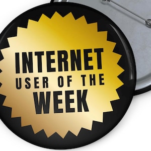 May include: A black and gold button with the text "INTERNET USER OF THE WEEK" on a gold starburst.