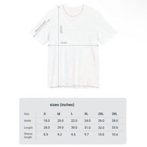 May include: A white t-shirt with measurements for width, length, and sleeve length. The size chart shows measurements in inches for sizes S through 3XL. The width ranges from 18.0 to 28.0 inches, length from 28.0 to 33.0 inches, and sleeve length from 8.9 to 10.4 inches.