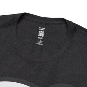 May include: A black t-shirt with a white tag that says "Brain Wash" and has a QR code. The tag also says "Only" and "L" for size. The tag also includes care instructions.