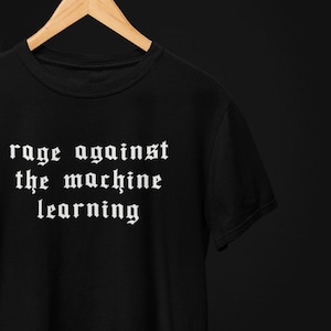 Può includere: Maglietta nera con testo bianco che recita "rage against the machine learning" in un font gotico.
