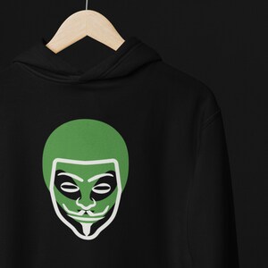 May include: Black hoodie with a green and white graphic of a stylized face wearing a mask.