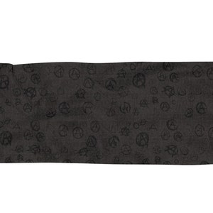 May include: A black scarf with a repeating pattern of anarchy symbols. The scarf has a fringed edge.