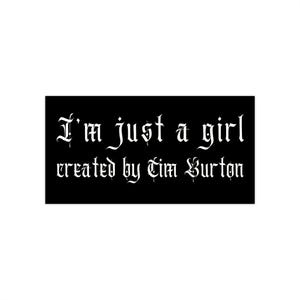 May include: A black rectangle with white text that reads "I'm just a girl created by Tim Burton" in a gothic font. The text is centered and the background is solid black.