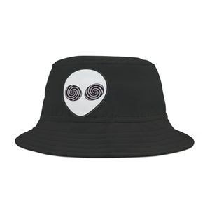 May include: Black bucket hat with a white alien face with swirling black eyes.