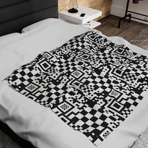 May include: Black and white checkered bedding with a geometric pattern. The pattern resembles a QR code.