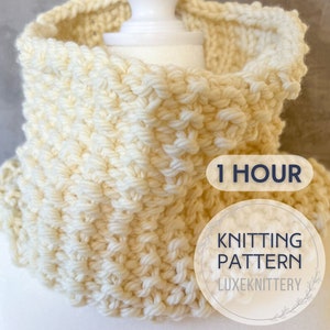 May include: A white knitted cowl neck scarf with a 1 hour knitting pattern label. The label also says "Knitting Pattern" and "Luxeknittery".