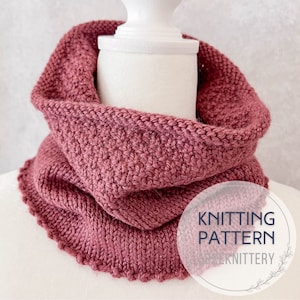 May include: A knitting pattern for a pink cowl with a scalloped edge. The pattern is called "The Simple Knittery".
