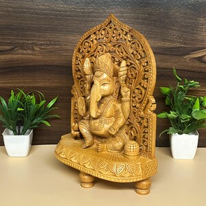 collectible Hindu deities, Hindu festival gifting item, Lord Ganesha wooden idol gift set, meditative decor elements, handmade religious carvings, elephant-headed god statue, ethnic divine home decor, Indian craft wooden murti, peaceful home shrine decoration, symbolic wooden artwork, wooden Hindu divine figure, energy balancing idol, and Indian heritage wooden decor