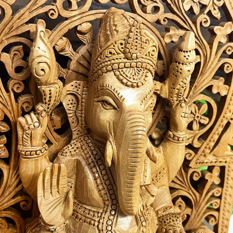ethnic wooden figurine, Indian handicraft decor, handmade wooden god statue, auspicious home decoration, handcrafted spiritual idol, religious gift for parents, Lord Ganesha sculpture, divine blessing idol, prosperity symbol statue, Diwali puja decor, best pooja room idols, carved wooden ganesha murti, vintage Indian god statue, elephant god idol, wooden deity sculpture, cultural Hindu artwork, sacred altar decoration, divine housewarming present