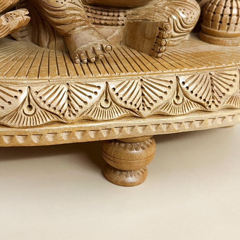 fine wood sculpture of Ganesha, temple decoration ideas, wooden statue for spiritual space, collectible Hindu deities, Hindu festival gifting item, Lord Ganesha wooden idol gift set, meditative decor elements, handmade religious carvings, elephant-headed god statue, ethnic divine home decor, Indian craft wooden murti, peaceful home shrine decoration, symbolic wooden artwork, wooden Hindu divine figure, energy balancing idol, and Indian heritage wooden decor.