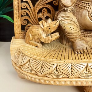 vastu shastra ganesha idol, carved wooden god sculpture, divine energy showpiece, temple pooja item, auspicious wooden statue, decorative Indian god figurine, sacred spiritual ornament, artisan-crafted Hindu murti, decorative wooden figurine, festive home decoration, religious wooden idol gift, wooden ganesh for car dashboard, Hindu god idol collection, traditional Indian wood art, miniature wooden ganesha statue, pooja essentials for home, religious decorative showpiece