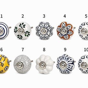 May include: A selection of ten ceramic cabinet knobs with various designs. These include knobs with blue and white stripes, green leaves, and floral patterns. The knobs have a silver metal base and are suitable for cabinets.