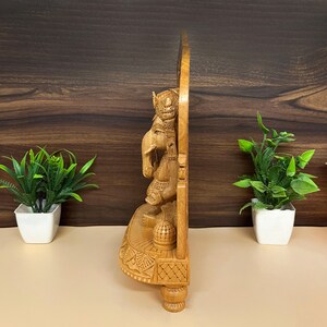artisan-crafted Hindu murti, decorative wooden figurine, festive home decoration, religious wooden idol gift, wooden ganesh for car dashboard, Hindu god idol collection, traditional Indian wood art, miniature wooden ganesha statue, pooja essentials for home, religious decorative showpiece, fine wood sculpture of Ganesha, temple decoration ideas, wooden statue for spiritual space