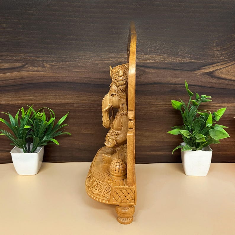 artisan-crafted Hindu murti, decorative wooden figurine, festive home decoration, religious wooden idol gift, wooden ganesh for car dashboard, Hindu god idol collection, traditional Indian wood art, miniature wooden ganesha statue, pooja essentials for home, religious decorative showpiece, fine wood sculpture of Ganesha, temple decoration ideas, wooden statue for spiritual space