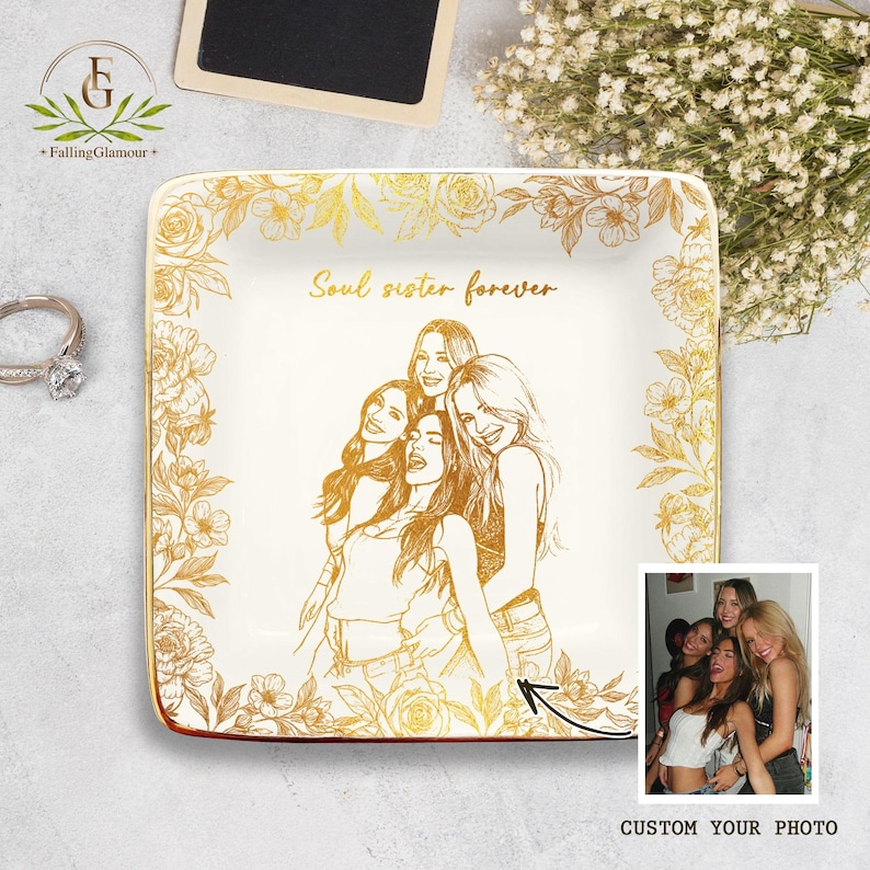 May include: Square ceramic trinket dish with a gold floral border and the words "Soul sister forever". The center features a gold illustration of five women and a photo. The dish is white with gold accents.