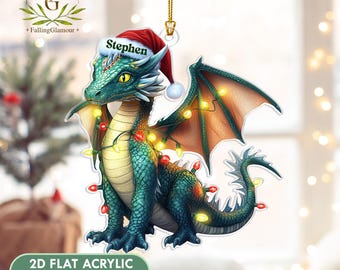 May include: A Christmas ornament featuring a teal dragon wearing a Santa hat with the name "Stephen". The dragon is adorned with a string of Christmas lights. The ornament is made of 2D flat acrylic.
