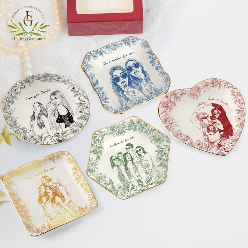 May include: A collection of decorative ceramic plates in various shapes, including round, square, and heart-shaped. Each plate features a unique illustration of people and floral borders, with text such as "Soul sister forever" and "Bestfriends for life".