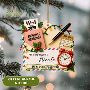 May include: A flat acrylic hanging ornament shaped like an envelope with text W-4 2026, Employee Handbook, Time Card, and Pay to the order of: Nicole, My New Job at Busystreet. It features a black pen, red alarm clock, and green holly leaves.