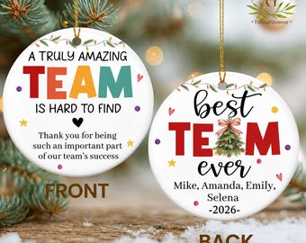 May include: Two round white ceramic ornaments with gold hanging strings. The left ornament reads A TRULY AMAZING TEAM IS HARD TO FIND and Thank you for being such an important part of our team's success. The right ornament reads best TEAM ever, Mike, Amanda, Emily, Selena, 2026, and features a Christmas tree.