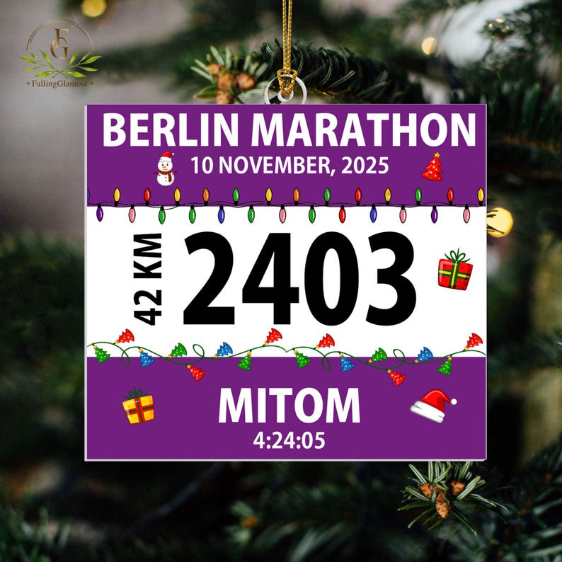 May include: A square purple and white ornament featuring the text BERLIN MARATHON, 10 NOVEMBER, 2025, 42 KM, 2403, MITOM, and 4:24:05. The design includes colorful Christmas light strings, a snowman, a red Christmas tree, gift boxes, and a Santa hat.