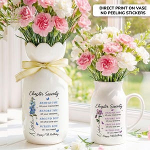 May include: A white ceramic vase and a matching mug, both featuring a scalloped rim and a direct print design. The text reads Chapter Seventy, Behind you all your memories, Before you all your dreams, Around you all who love you, Within you all you need.