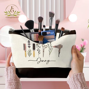 May include: A personalized makeup bag with a black zipper and bottom, filled with makeup brushes and palettes. The bag features a design of beauty tools and the name "Jenny" in script.