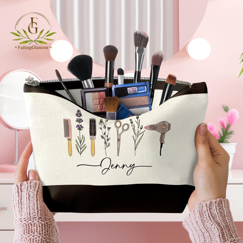 May include: A personalized makeup bag with a black zipper and bottom, filled with makeup brushes and palettes. The bag features a design of beauty tools and the name "Jenny" in script.