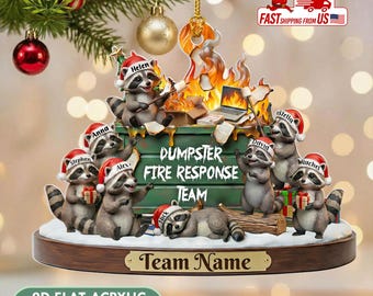 May include: A Christmas ornament featuring a team of raccoons wearing Santa hats, gathered around a dumpster fire. The ornament has the text "Dumpster Fire Response Team" and "Team Name". The ornament is 2D flat acrylic.
