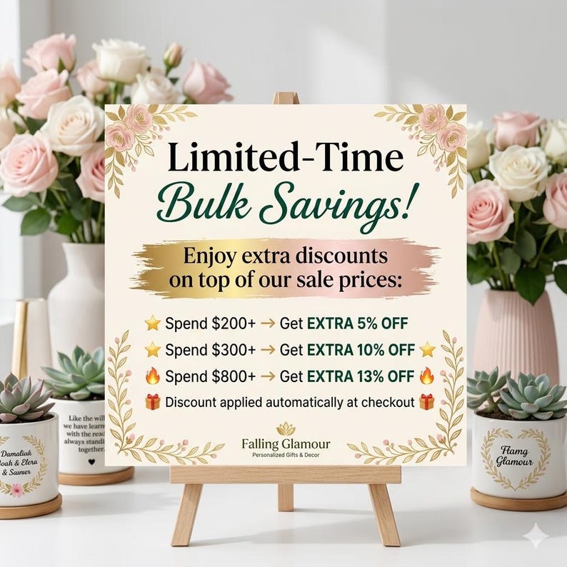 May include: A sign on a wooden easel with the text "Limited-Time Bulk Savings!" and details on extra discounts. The sign is decorated with floral accents and surrounded by vases of pink and white roses and succulent plants in decorative pots.