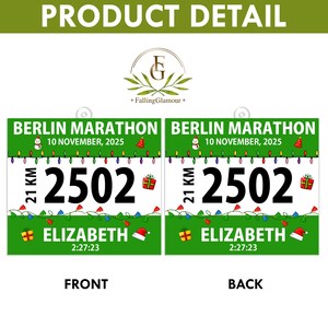 May include: A square race bib with a green border and white center featuring the text BERLIN MARATHON, 10 NOVEMBER, 2025, 21 KM, 2502, ELIZABETH, and 2:27:23. The design includes colorful string lights, gift boxes, a snowman, and a Santa hat.