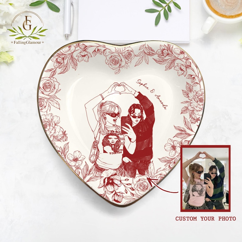 May include: Heart-shaped ceramic trinket dish with a red floral border and a central illustration of two people making a heart shape with their hands. The dish includes the text "Sophia & Amanda" and a small photo.