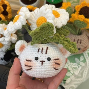 Amigurumi cat and flower pot made from yarn, sunflower home decoration