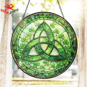 May include: Round stained glass window hanging with a green shamrock design. The window features a Celtic knot in the center and shamrocks around the edges. The text "SPECIAL JOYGIFTS" is in the upper left corner. The window is hanging from a chain.