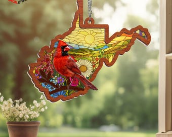May include: A wooden ornament in the shape of West Virginia, featuring a stained-glass design with a red cardinal perched on a branch with flowers. The ornament hangs from a silver chain. The text "SPECIAL JOY GIFTS" is in the upper left corner.