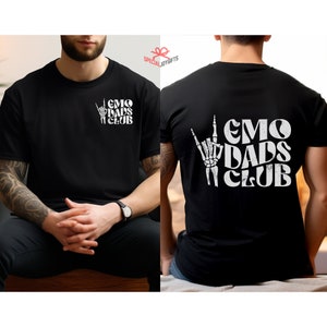 May include: Black t-shirt with a white graphic print of a skeleton hand making the rock and roll sign with the text "EMO DADS CLUB".