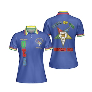 Puede incluir: Polo azul con las letras "OES" en verde, rojo y azul. La camisa presenta un cuello con ribetes amarillos, verdes y rojos, y la espalda muestra "ORDER OF THE EASTERN STAR" con un emblema de estrella. La camisa es de manga corta.