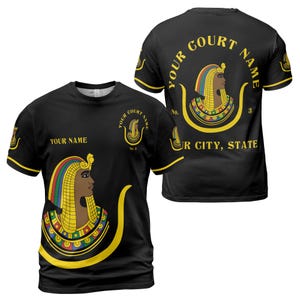May include: Black t-shirt with a gold and colorful design of an Egyptian queen's head. The text "YOUR COURT NAME" is written in a circle around the design. The text "YOUR NAME" and "YOUR CITY, STATE" are also included on the shirt.