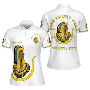 May include: White polo shirt with a gold design of an Egyptian queen with a colorful headdress. The text "YOUR COURT NAME" is in a gold circle on the back of the shirt. The text "YOUR CITY, STATE" is below the circle. The text "YOUR NAME" is on the front of the shirt.