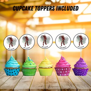 Puede incluir: Cinco cupcakes con glaseado colorido y adornos para cupcakes con el dise&ntilde;o de Iron Man. Los adornos dicen "Happy Birthday". Los cupcakes est&aacute;n en envoltorios azules, verdes, amarillos, rosas y morados, colocados sobre una superficie de madera. El texto "CUPCAKE TOPPERS INCLUDED" est&aacute; en la parte superior.