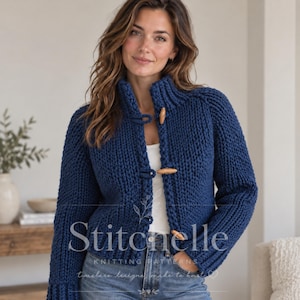 May include: A chunky knit navy blue cardigan featuring a high collar and three light brown wooden toggle buttons down the front. The garment is worn over a white top and blue denim jeans. The text Stitchuelle Knitting Patterns is visible.