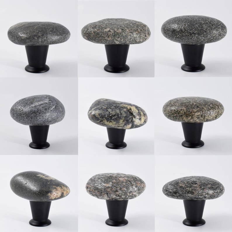 Polished natural stone knobs installed on a wooden dresser, emphasizing subtle coastal textures and unique pebble shapes. These handmade beach stone pulls are perfect for drawers, sideboards, or cabinets, adding an organic, tactile accent to furniture while enhancing Scandinavian, modern rustic, or bohemian interior designs with understated elegance.