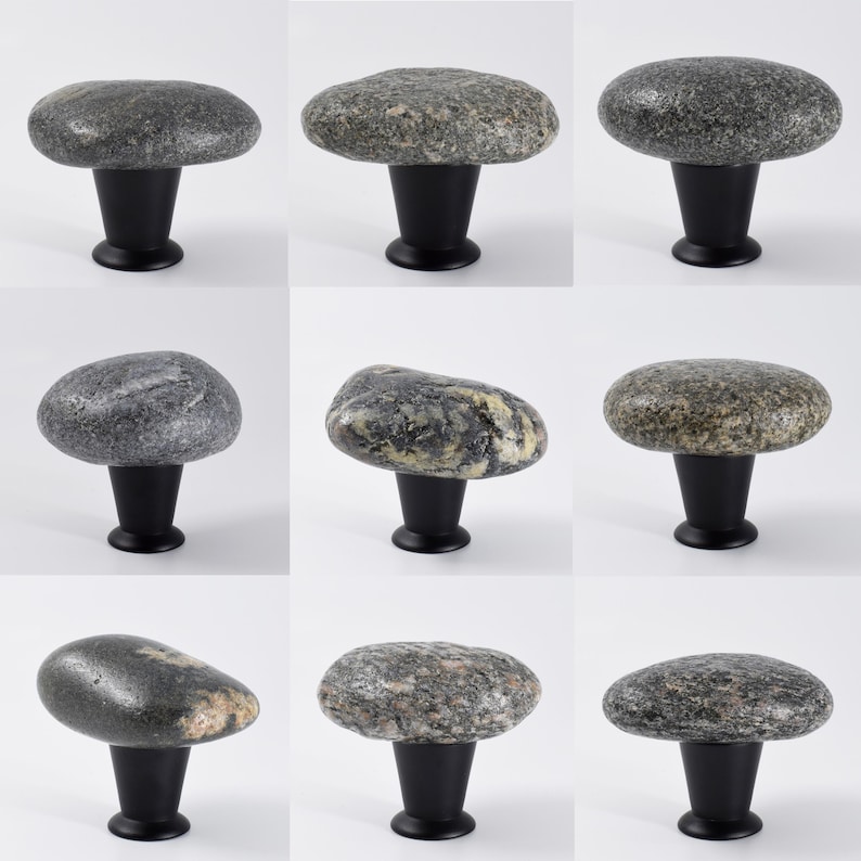 Artisan-crafted rock knobs on a sideboard, emphasizing irregular shapes and smooth, polished finishes. These handmade beach stone drawer pulls are ideal for cabinets, storage units, or nightstands, adding tactile and visual appeal while enhancing interior design with coastal elegance, rustic charm, and natural, one-of-a-kind beauty.