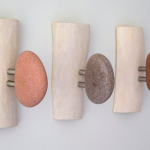 Sea stone robe door hangers, robe and towel hooks, wood robe hook. Outdoor robe hooks with smooth stones. Bathroom hooks and robe hangers with beach stone. Wall coat racks with shelf metal coat rack for wall. Wall mounted stone coat racks.