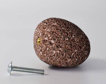 May include: A brown, rough, oval-shaped lava rock knob with a threaded metal screw. The screw is attached to a silver metal screw.